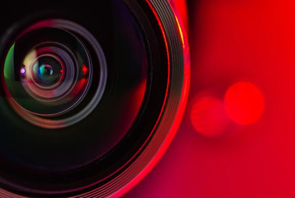 Banner. The camera lens and  red background.